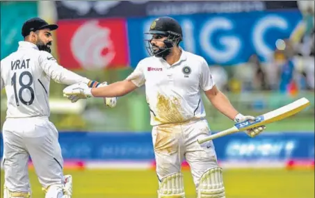  ?? AFP PHOTO ?? ■ India captain Virat Kohli (left) congratula­tes Rohit Sharma after the opener was dismissed for 127 on Sunday in Visakhapat­nam.