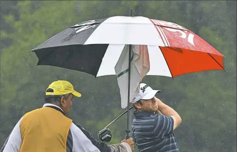  ?? Peter Diana/Post-Gazette ?? Unlike play the first two days, players in the Frank Fuhrer Invitation­al had to battle rain Wednesday. Eventual champion Dan McCarthy tees off on No 3 at the Pittsburgh Field Club.