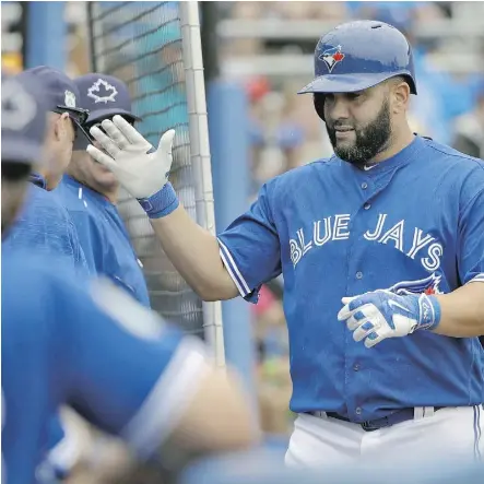  ?? CHRIS O’MEARA/THE ASSOCIATED PRESS ?? Toronto Blue Jays sluggger Kendrys Morales high-fives teammates after his home run against the Boston Red Sox on Monday in Dunedin, Fla. Morales is hitting .474 in spring training.