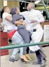  ??  ?? TAKE OUT: A man hauls away a woman, snagging a waiter in the process, amid a caught-on-video melee at Carmine’s on Thursday. Three women from Texas were arrested in the incident.