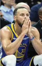  ?? GODOFREDO A. VÁSQUEZ / ASSOCIATED PRESS ?? Golden State guard Stephen Curry rests in the second half of Tuesday’s play-in tournament game against Sacramento. The Kings won to clinch a spot in the playoffs and avenge a Game 7 loss to the Warriors last season.