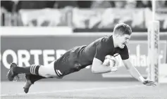  ??  ?? (FILES)This file photo taken on July 8,2017 shows New Zealand’s fly-half Beauden Barrett scoring a try during the third rugby union Test match between the British and Irish Lions and New Zealand All Blacks at Eden Park in Auckland. All Blacks star...