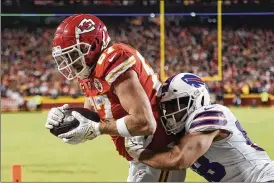  ?? CHARLIE RIEDEL / AP ?? Kansas City Chiefs tight end Travis Kelce catches an 8-yard touchdown pass over Buffalo Bills outside linebacker Matt Milano during overtime in an NFL divisional round game Sunday in Kansas City, Mo. The Chiefs won 42-36. The win lifted Kansas City to the AFC Championsh­ip Game at home against the Cincinnati Bengals.