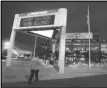  ?? Associated Press ?? The marquee in front of the Energy Solutions Arena, formerly the Delta Center, home of the Utah Jazz, shows conflictin­g signage at dusk before a game against the Toronto Raptors, Nov. 20, 2006, in Salt Lake City.