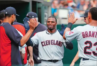  ?? PAUL SANCYA/AP PHOTO ?? Rajai Davis of the Indians celebrates scoring in the eighth inning of Sunday’s game against the Tigers at Detroit. Davis, the former New London High School and Avery Point star, had two doubles and a triple as the Indians won 8-1.