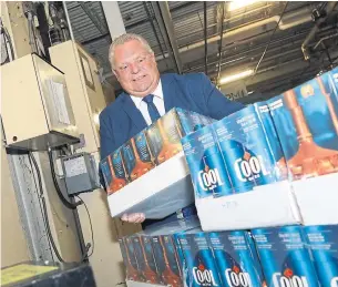  ?? RENÉ JOHNSTON TORONTO STAR ?? Premier Doug Ford marks the introducti­on of “buck-a-beer” with a visit to the Cool Beer Brewing Co. in Etobicoke, one of the few brewers taking part in the province’s new plan.