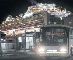  ?? REUTERS ?? A bus transports British passengers after they leave the coronaviru­s-hit ‘Diamond Princess’ at Daikoku Pier Cruise Terminal in Yokohama on Saturday.