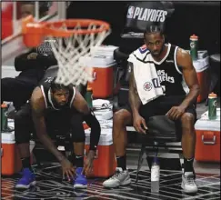  ?? OC Register via AP ?? GAME-MINDED — The Clippers’ Paul George (left) and teammate Kawhi Leonard look on in the fourth quarter of Game 3 of the Western Conference second-round playoffs against the Utah Jazz at the Staples Center in Los Angeles on June 12. Leonard is out with a knee injury, but is still finding ways to help his team win games.