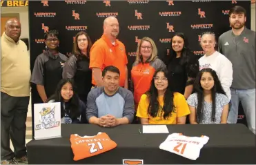  ?? Scott Herpst ?? Cynthia, Alex, and Jasmin Felipe were among those on hand last week to watch LaFayette senior Daisy Felipe sign on to play volleyball at Lees-McRae College. Also present for the ceremony were LHS administra­tors Jeff Suttle, Lugenia Suttles, Judy Blaylock, Ronnie Massey and Maggie Stultz, LHS assistant coach Timerra Kingsley, Saddle Ridge head coach Sherry Swanson and LHS head coach Chris Logan.