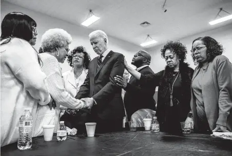  ?? Brittainy Newman / New York Times ?? Clara Jones leads former Vice President Joe Biden and others in a prayer Jan. 5 before he spoke at Corinthian Baptist Church in Des Moines, Iowa, where Democrats will caucus Feb. 3. A recent poll finds Biden in fourth place in a tight contest there.