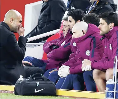  ?? AP ?? Manchester City coach Josep Guardiola speaks to his coaching staff during the Champions League quarter-final first-leg match against Liverpool at Anfield stadium in Liverpool on Wednesday.