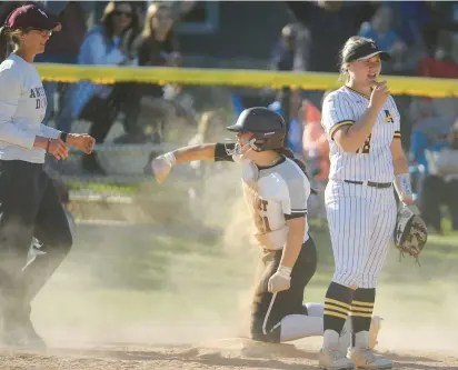  ?? STEVE JOHNSTON/DAILY SOUTHTOWN PHOTOS ?? ABOVE: Lockport’s Sarah Viar reacts after sliding in to third base for a triple against Andrew during the Class 4A Lockport Regional championsh­ip game on Friday. BELOW: Lockport’s Brooke Keltner follows through on a swing against Andrew.