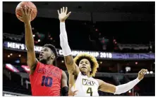  ?? DAVID JABLONSKI / STAFF 2018 ?? Dayton’s Jalen Crutcher shoots against Virginia Commonweal­th’s Justin Tillman in 2018. Tillman is on a team with many former Flyers competing in The Basketball Tournament.