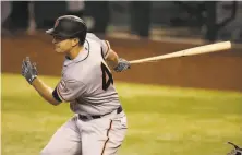  ?? Christian Petersen / Getty Images ?? Giants outfielder Alex Dickerson drives in a run with an eighthinni­ng single in a win over Arizona.