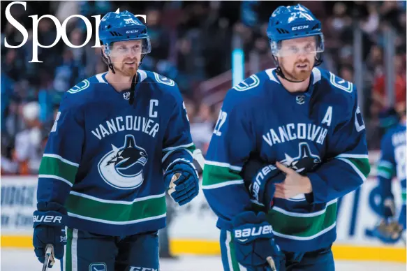  ?? CP PHOTO ?? Vancouver Canucks players Henrik and Daniel Sedin hit the ice before a game against the Anaheim Ducks,in Vancouver on March 27. The Sedin twins will retire after the end of this NHL season.
