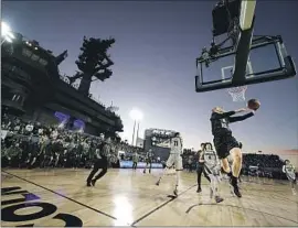  ?? Ashley Landis Associated Press ?? MICHIGAN STATE’S Joey Hauser hits a layup against second-ranked Gonzaga in the Carrier Classic aboard the USS Abraham Lincoln. Gonzaga won 64-63.