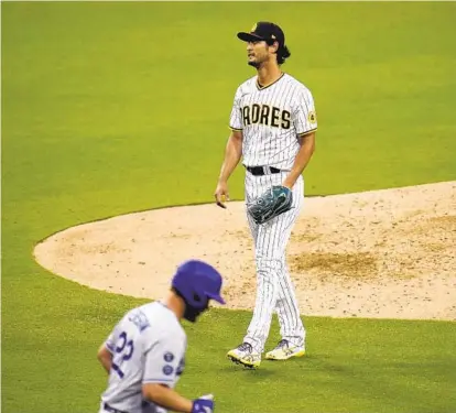  ?? GREGORY BULL AP ?? Padres starting pitcher Yu Darvish reacts after walking Dodgers’ Clayton Kershaw with the bases loaded last Saturday.