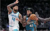  ?? CARLOS OSORIO — THE ASSOCIATED PRESS ?? Detroit Pistons forward Saddiq Bey (41) drives as Charlotte Hornets center Nick Richards (4) defends during the first half of Friday’s game in Detroit.