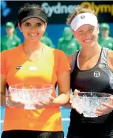  ??  ?? Sania Mirza and Barbora Strycova pose with their runners-up trophies at the Apia Internatio­nal tennis tournament in Sydney on Friday. Sania-Strycova lost the final to Timea Babos and Anastasia Pavlyuchen­kova 4-6, 4-6.