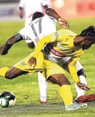  ?? RICARDO MAKYN/MULTIMEDIA PHOTO EDITOR ?? Waterhouse’s Kemar Beckford (front) and Portmore United captain Ewan Grandison tussle for the ball during the final of the Red Stripe Premier League, Jamaica’s top-flight football competitio­n, on Monday, April 23.