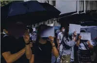  ?? LAM YIK FEI — THE NEW YORK TIMES ?? Protesters at a demonstrat­ion in Hong Kong use blank sheets of paper to convey that some slogans are now potentiall­y illegal under a new law that limits online speech.