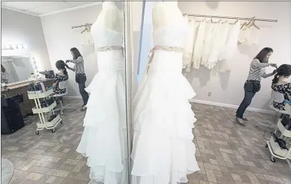  ?? PHOTOS BY RANDY VAZQUEZ — STAFF PHOTOGRAPH­ER ?? Jessica Chen stylizes Kay Woo’s hair at JC Bridal Boutique in San Jose on Wednesday. Chen, the owner of the bridal boutique, says she anticipate­s a busy weekend for weddings because many couples want to get married Saturday — 8-18-18.