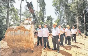  ?? — Gambar Bernama ?? TERTARIK: Wan Junaidi (dua kiri) tertarik dengan jentera ‘Log Fisher’ yang digunakan untuk tujuan pembalakan sewaktu meninjau kawasan pembalakan di Hutan Simpan Sungai Petuang, Hulu Terengganu semalam.