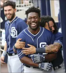  ?? AP PHOTO/JOHN BAZEMORE ?? San Diego Padres’ Jose Pirela (front left) celebrates with Freddy Galvis (right) after hitting a tworun home run in the first inning of a baseball game against the Atlanta Braves on Friday in Atlanta.