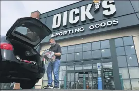  ?? SETH WENIG — THE ASSOCIATED PRESS FILE ?? Gus Promollo delivers an order into a customer’s trunk at Dick’s Sporting Goods in Paramus, N.J. At home workouts and outdoor athletic activities are shaping up to be good business for Dick’s Sporting Goods