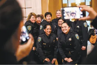  ?? Gabrielle Lurie / Special to The Chronicle ?? Female SFPD officers gather for a photograph during a celebratio­n of 40 years of women in patrol at City Hall in San Francisco. Two classes of female officers graduated in 1975.