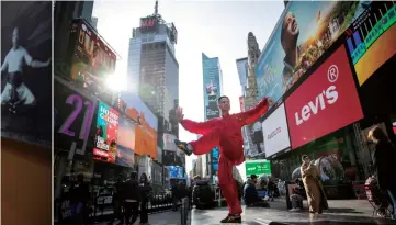  ?? (Photo by VCG) ?? Left: A wushu demonstrat­ion at the opening ceremony of the 16th World Wushu Championsh­ips, Fort Worth, Texas, US, November 16, 2023
Center: A father and son visit the Wong Fei-hung Memorial Hall, Foshan, Guangdong Province, November 4, 2023. Wong Fei-hung (1847-1925) was a famous kung fu practition­er (Photo by VCG)
Right: Chen Sitan, winner of the 2nd World Wushu Championsh­ips in 1993, performs tai chi in Times Square, New York City, December 17, 2021 to mark the anniversar­y of the inclusion of tai chi in the UNESCO Intangible Cultural Heritage of Humanity (Photo by VCG)