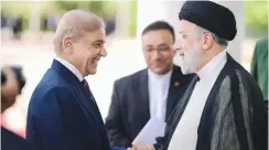  ?? (Pakistani Prime Minister’s Office/Reuters) ?? PAKISTAN’S PRIME Minister Shehbaz Sharif (left) greets Iranian President Ebrahim Raisi in Islamabad last month.