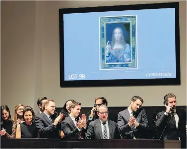  ??  ?? Bidding representa­tives react after Leonardo da Vinci’s Salvator Mundi sold Wednesday evening in New York.