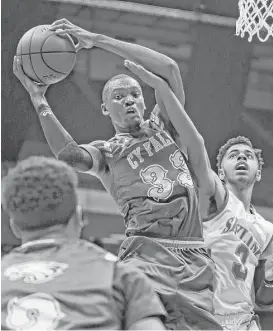  ?? Ron Cortes ?? Deshang Weaver of Cypress Falls grabs a rebound next to Dallas Skyline’s Jase Townsend during the Class 6A boys basketball semifinal Friday night.