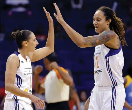  ?? MATT YORK — THE ASSOCIATED PRESS FILE ?? Phoenix Mercury guard Diana Taurasi, left, high-fives teammate Brittney Griner during the first half of a WNBA basketball game against the Chicago Sky, on July 2, 2014, in Phoenix.