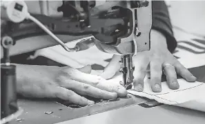  ??  ?? Nicholas Rosinski, 31, of Clinton Twp., Mich., is a trim technician who is now sewing together Tyvek medical gowns at General Motors Design Studio at Warren Technical Center for the medical industry battling COVID- 19.