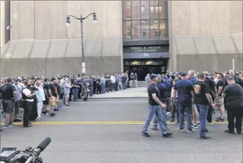  ?? Madison Carter/ WKBW via AP ?? Supporters of two suspended Buffalo police officers assemble Saturday outside the courthouse in Buffalo. Prosecutor­s say both officers were charged with assault, after a video showed them shoving a 75-year-old protester at a demonstrat­ion over George Floyd’s death.