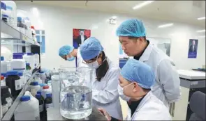  ?? SUN FEI / XINHUA ?? Bottom left: Researcher­s perform tests at the laboratory of a biotech company in Shenzhen, Guangdong province.