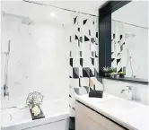  ??  ?? The one-bedroom show suite bathroom has marble-look tiles, a standout feature.