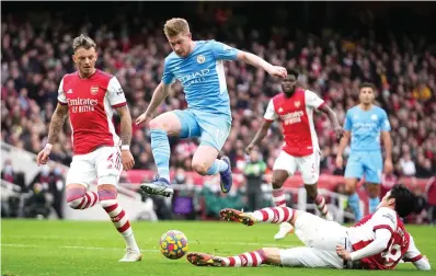  ?? AP Photo/Matt Dunham ?? Arsenal’s Takehiro Tomiyasu, right, challenges Manchester City’s Kevin De Bruyne during the Premier League soccer match Saturday between Arsenal and Manchester City at the Emirates Stadium, in London, England.