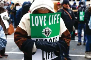  ?? Shafkat Anowar/The Dallas Morning News via AP ?? A marcher prays ahead of the North Texas March for Life, celebratin­g the passage and court rulings upholding the Texas law known as Senate Bill 8, on Jan. 15 in Dallas.