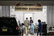  ?? ?? Alex Tseo, center, chats with customers at the Ebi Ebi Shrimp Fishing. Tseo, a Taiwanese-American, got the business idea from trips to Taiwan as a kid.