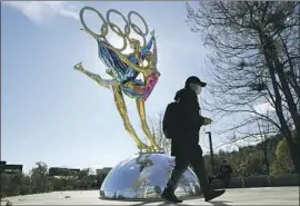  ?? Ng Han Guan Associated Press ?? DESPITE a government boycott, Canada, the U.K. and the U.S. will send athletes to the 2022 Winter Olympics. Above, a sculpture for the Games in a Beijing park.