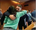  ?? ?? Above: Buck Myre, right, shakes hands with Steve St. Juliana, left, and Craig Shilling, center, after the sentencing of James and Jennifer Crumbley on Tuesday. Below: Buck Myre hugs Reina St. Juliana, Hana St. Juliana’s sister.