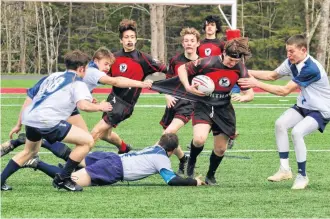  ?? ?? With a bitter wind blowing, the Nighthawks and Cheetahs vied for the right to advance to the boys’ rugby final April 24.