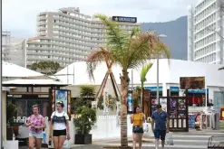  ??  ?? TENERIFE: This file photo taken on July 10, 2017 shows Holiday makers stroll through the tourist zone south of Tenerife on Spain’s Canary island. —AFP