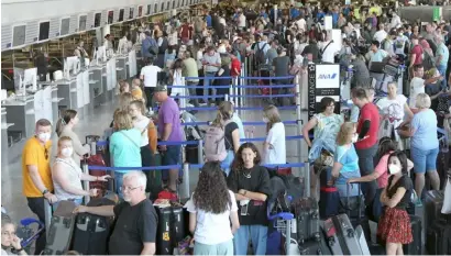  ?? DANIEL ROLAND/AGENCE FRANCE-PRESSE ?? PASSENGERS wait and queue in front of counters for departure at Frankfurt Airport in Frankfurt am Main, western Germany as employees of national carrier Lufthansa airline were called to strike.