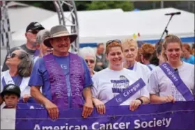  ?? MARIAN DENNIS — DIGITAL FIRST MEDIA ?? Relay for Life Grand Marshal Russ Oister walks with his family in the first lap of the relay. The event kicked off Saturday and continued through the night into Sunday morning.