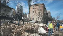  ?? EFREM LUKATSKY / ASSOCIATED PRESS ?? Volunteers and students clear the rubble of destroyed buildings in Kyiv on Saturday.