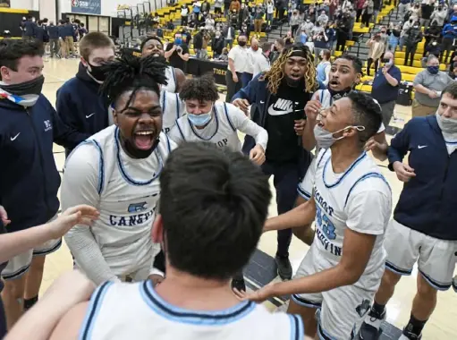  ?? Barry Reeger/For the Post-Gazette ?? Bishop Canevin’s Jhamil Fife (5) and Ngai Avery celebrate with their teammates after defeating Rochester, 42-27, in the WPIAL Class 1A boys championsh­ip game Friday at North Allegheny High School.